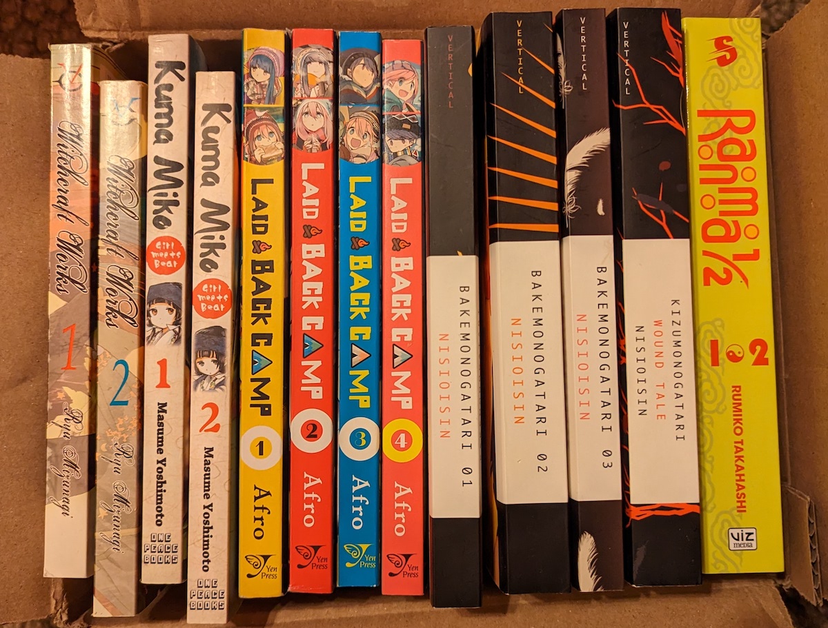 Various manga and light novel volumes sitting in a cardboard box, about to be taken to a used bookstore.